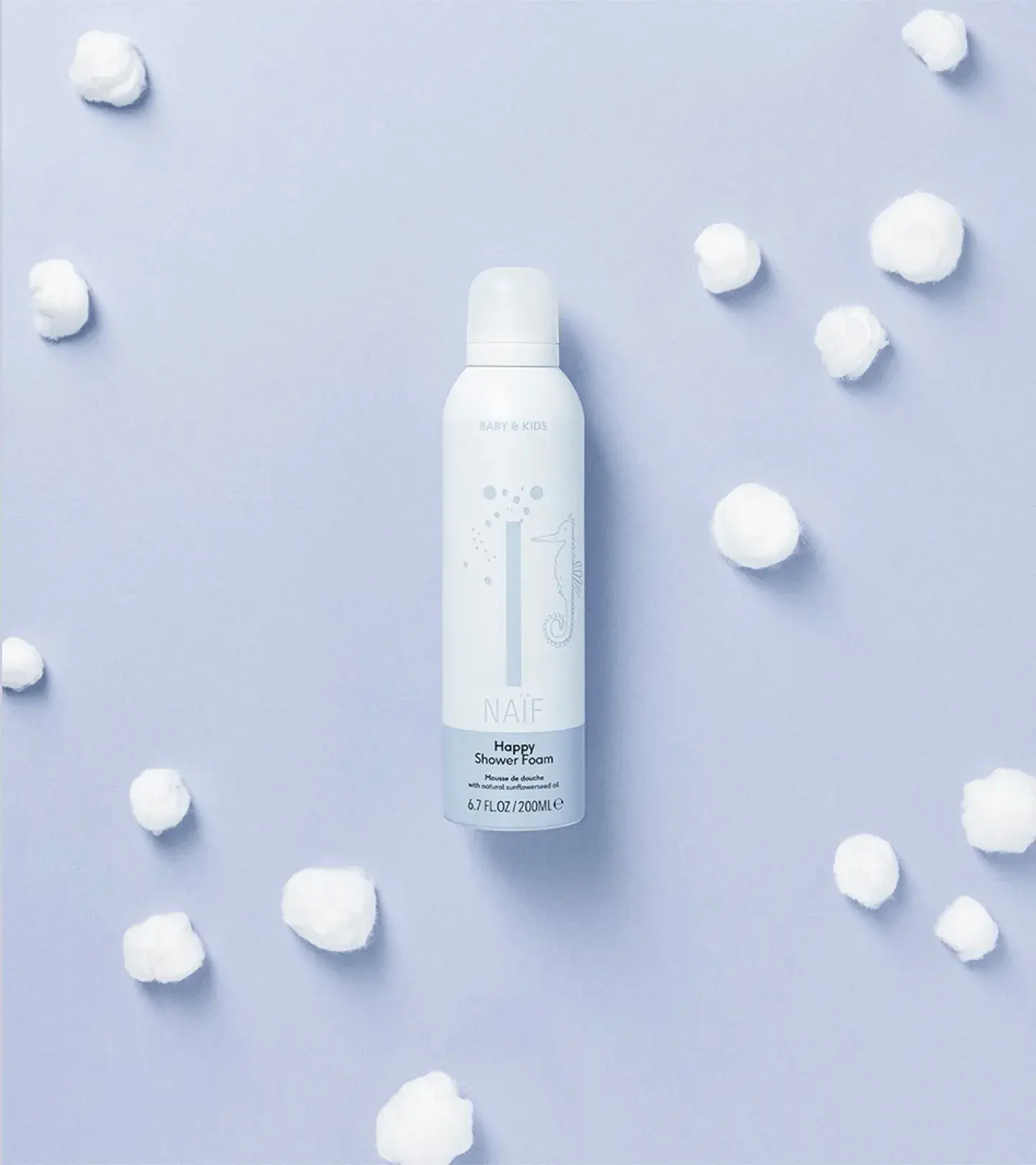 An image of the product happy shower foam on a purple background with cotton