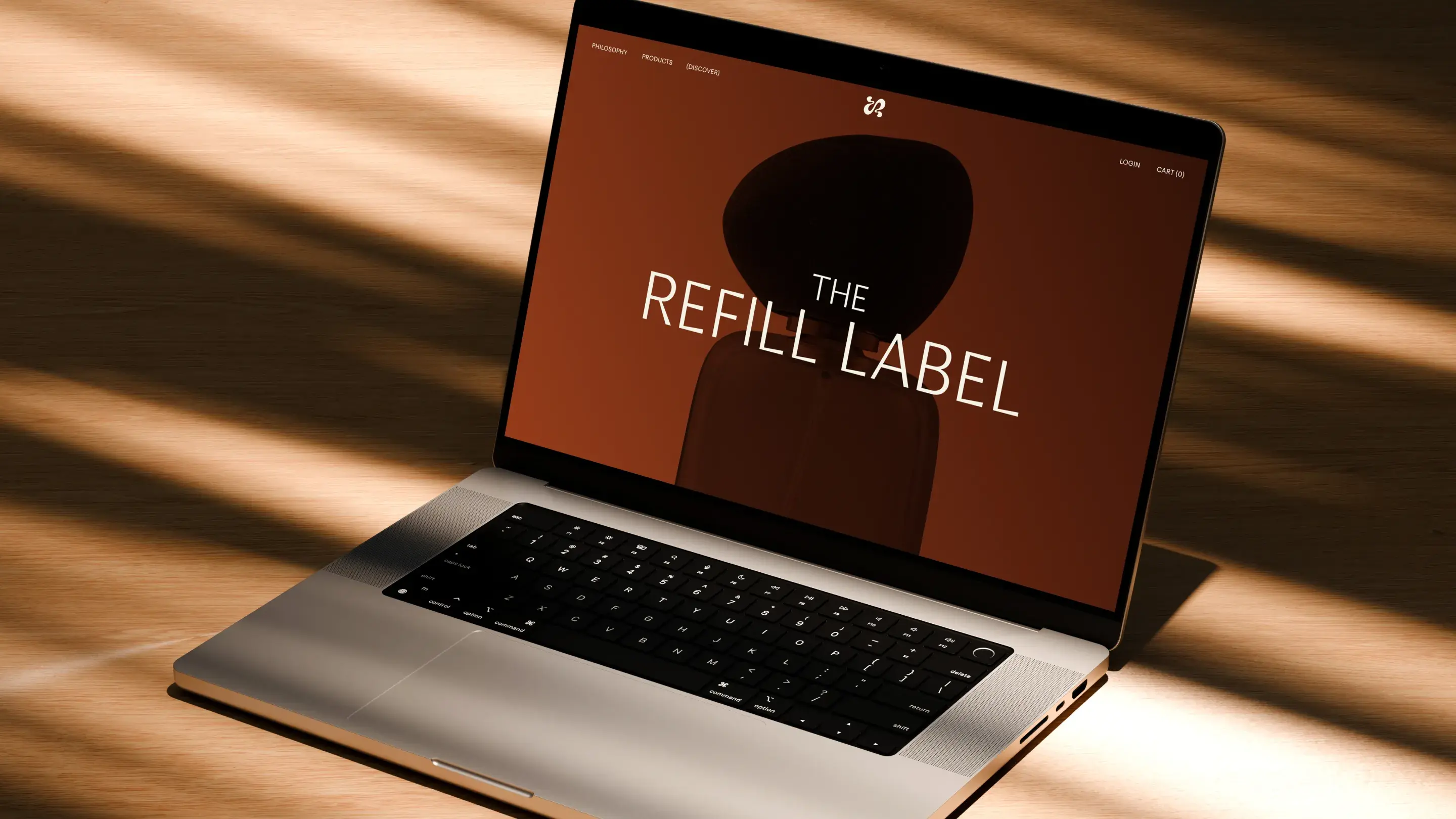Laptop with website mockup design for The Refill Label