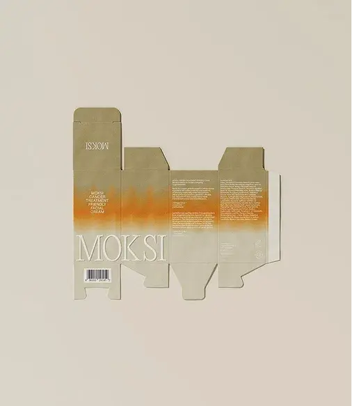 Flatlay of a partially assembled cardboard box with 'MOKSI' branding. Earthy tones with orange accents and text details visible.